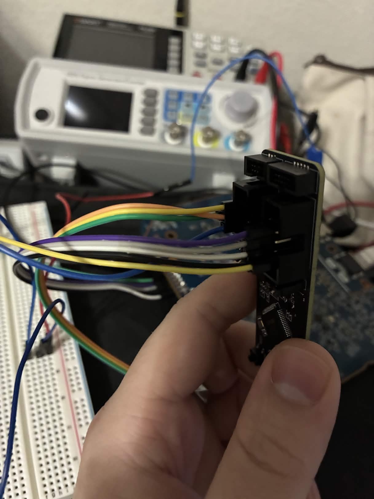 ESP-Prog JTAG connector wired up, bench PSU visible in background